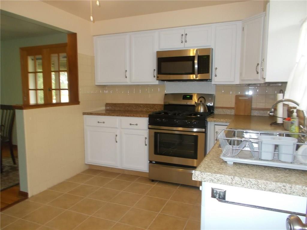 132 Starling Drive McKees Rocks, PA 15136 - Photo 12 of 25 Additional view of the kitchen, Ceramic tile floors, new white cabinets, semi open concept to dining area