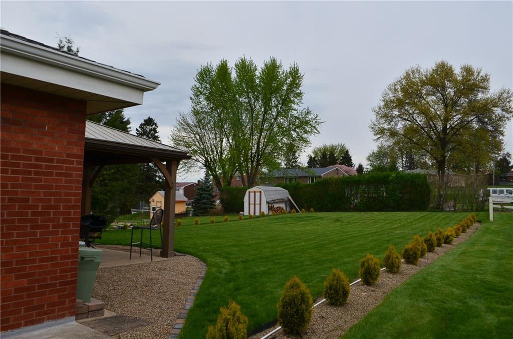 132 Starling Drive McKees Rocks, PA 15136 - Photo 4 of 25 Side site perspective / The owner planted 40 of these Thuja Forever Goldie Arborvitae shrubs with easy irrigation system, landscape stones/walking stones placed. Rear covered "Gazebo" styled patio / metal roof/ QUALITY!