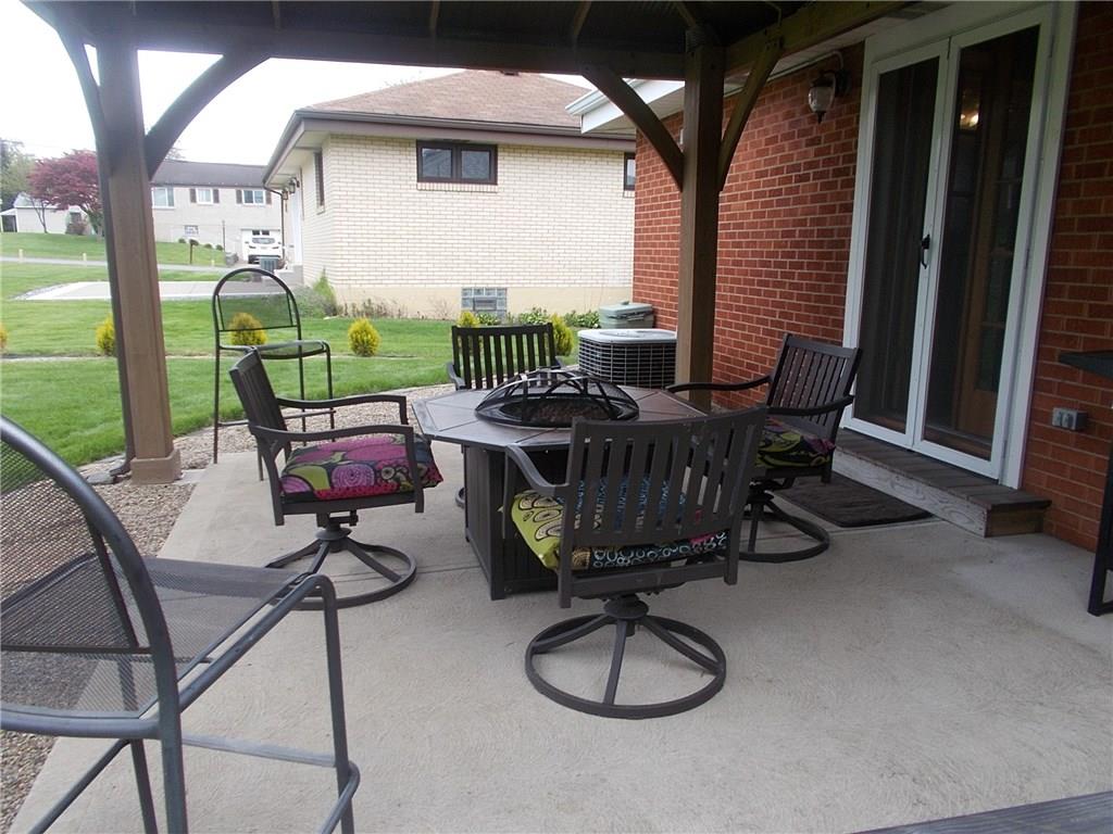 132 Starling Drive McKees Rocks, PA 15136 - Photo 5 of 25 New "Yardsley" Gazebo style covered back patio with metal roof. Double french storm doors to dining room / round walking and landscape stones surrounding the patio