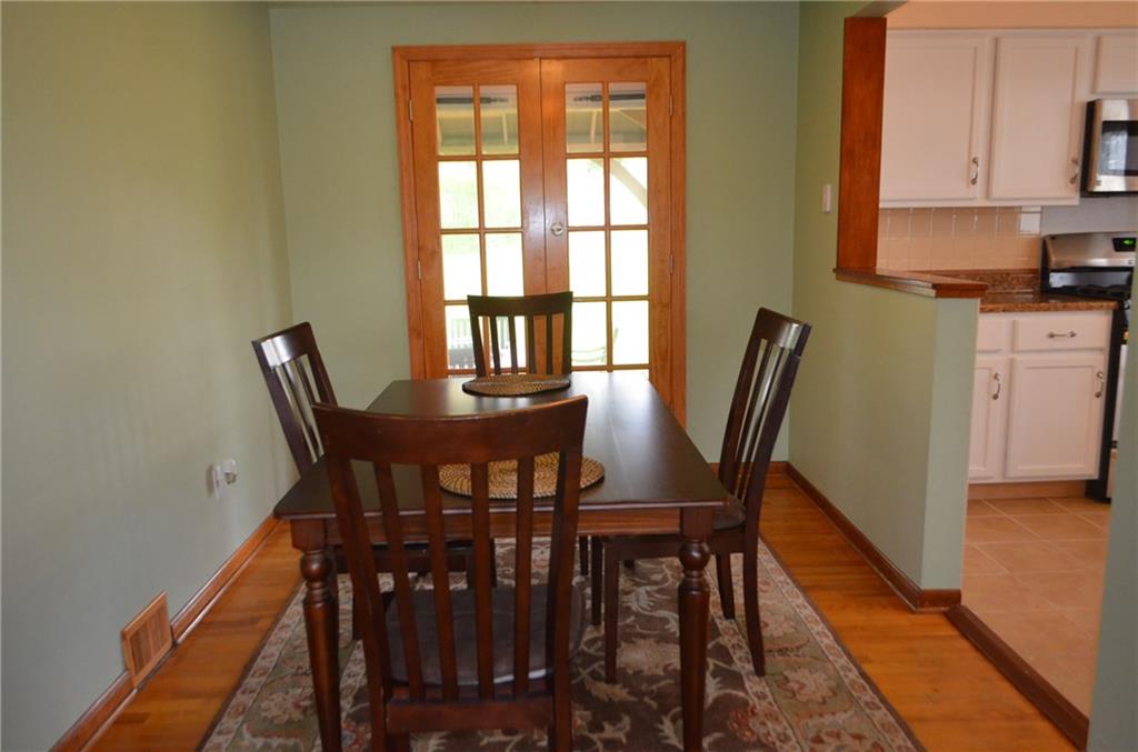 132 Starling Drive McKees Rocks, PA 15136 - Photo 8 of 25 Dining Room / refinished hardwood floors, new french doors installed leading to back patio, semi open concept to the newly remodeled kitchen