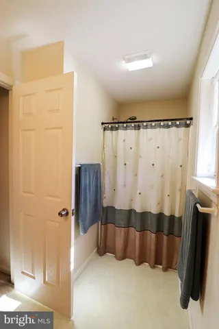 a bedroom with a bed and a ceiling fan