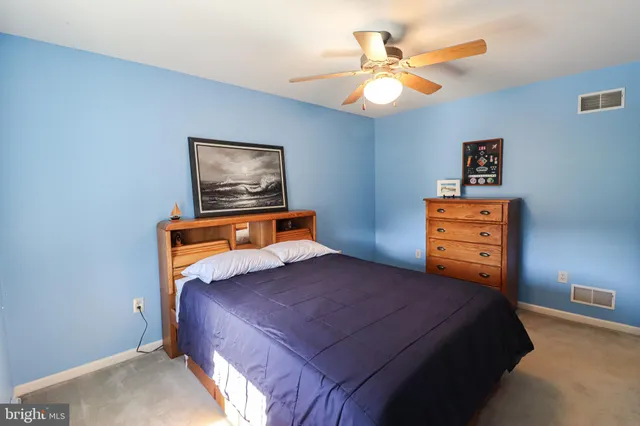 a bed room with a bed and a chandelier