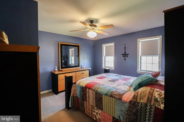 a room with wooden floor pool table and a chandelier