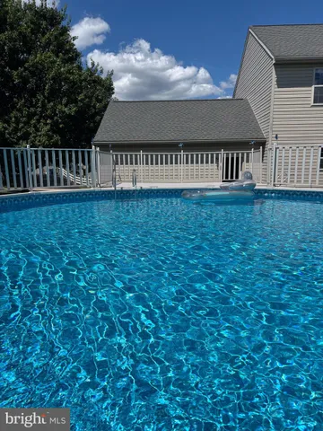 a view of a roof deck with wooden fence and a floor to ceiling window