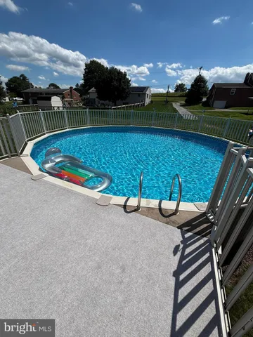 a view of a chair and table in the grass