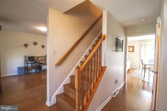 a view of dining room with wooden floor and stairs