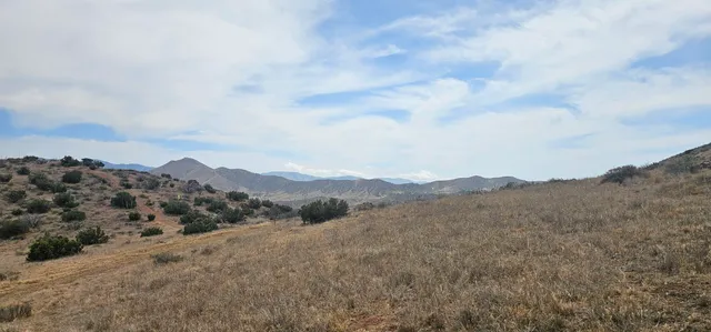 an aerial view of mountains in the background