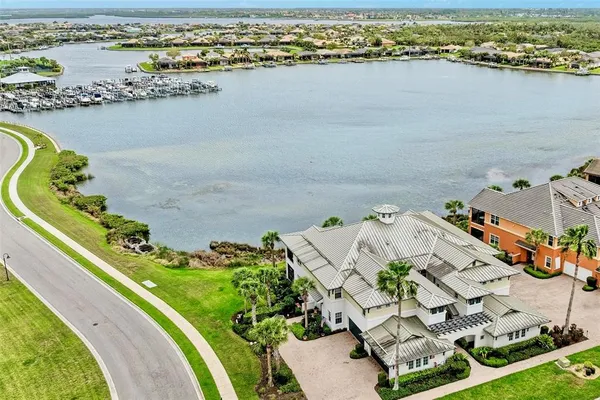an aerial view of lake and residential houses with outdoor space