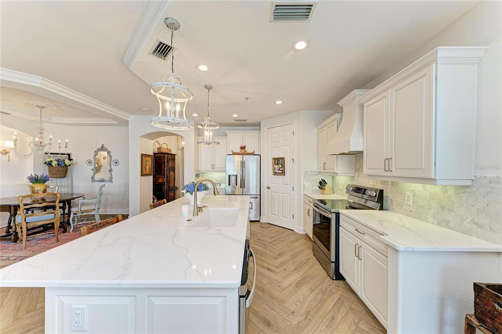 1151 Riverscape Street, Unit 1151 Bradenton, FL 34208 - Photo 21 of 62 a large white kitchen with lots of counter space a sink appliances and cabinets