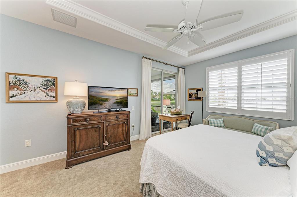 1151 Riverscape Street, Unit 1151 Bradenton, FL 34208 - Photo 29 of 62 a spacious bedroom with a bed and a flat screen tv