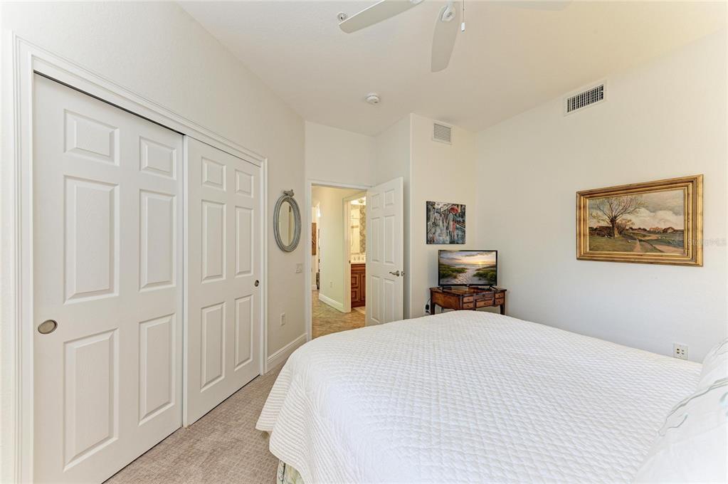 1151 Riverscape Street, Unit 1151 Bradenton, FL 34208 - Photo 38 of 62 a bedroom with a bed and a chandelier