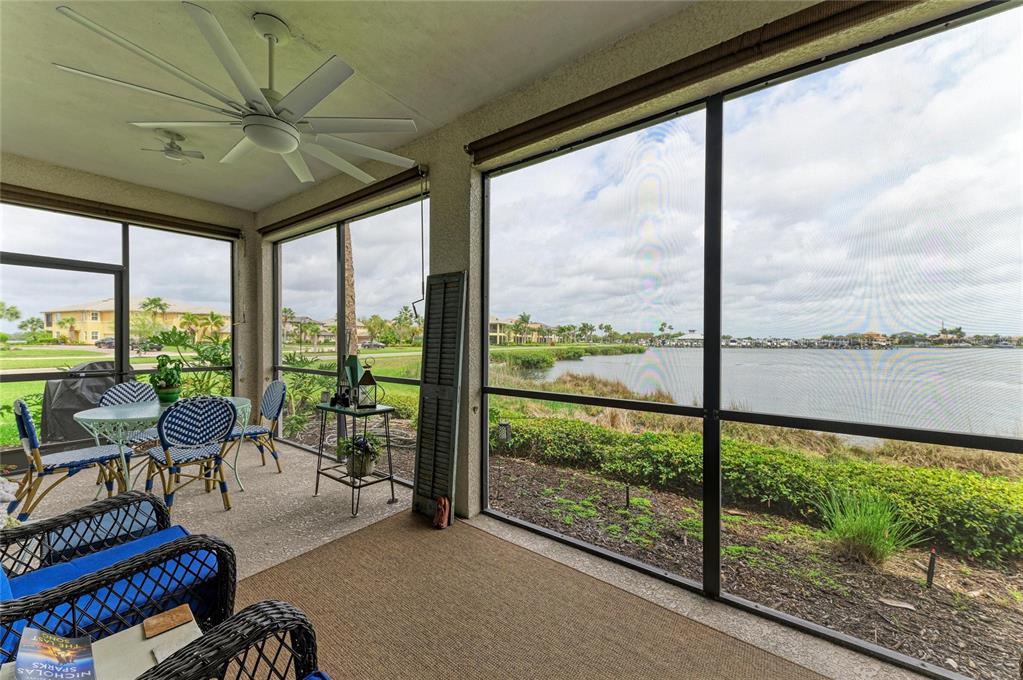 1151 Riverscape Street, Unit 1151 Bradenton, FL 34208 - Photo 41 of 62 a living room with furniture and a floor to ceiling window