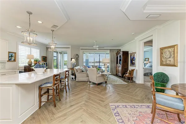 a view of a dining room with furniture and chandelier