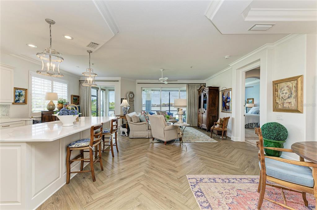 1151 Riverscape Street, Unit 1151 Bradenton, FL 34208 - Photo 9 of 62 a living room with lots of furniture and a chandelier