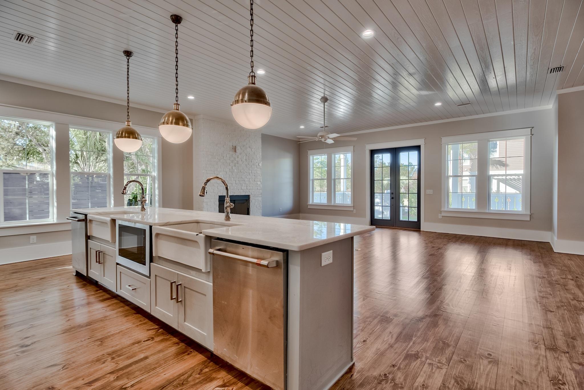 160 A St Inlet Beach Inlet Beach, FL 32461 - Photo 14 of 63 a kitchen with kitchen island granite countertop a stove a wooden floors and a large window