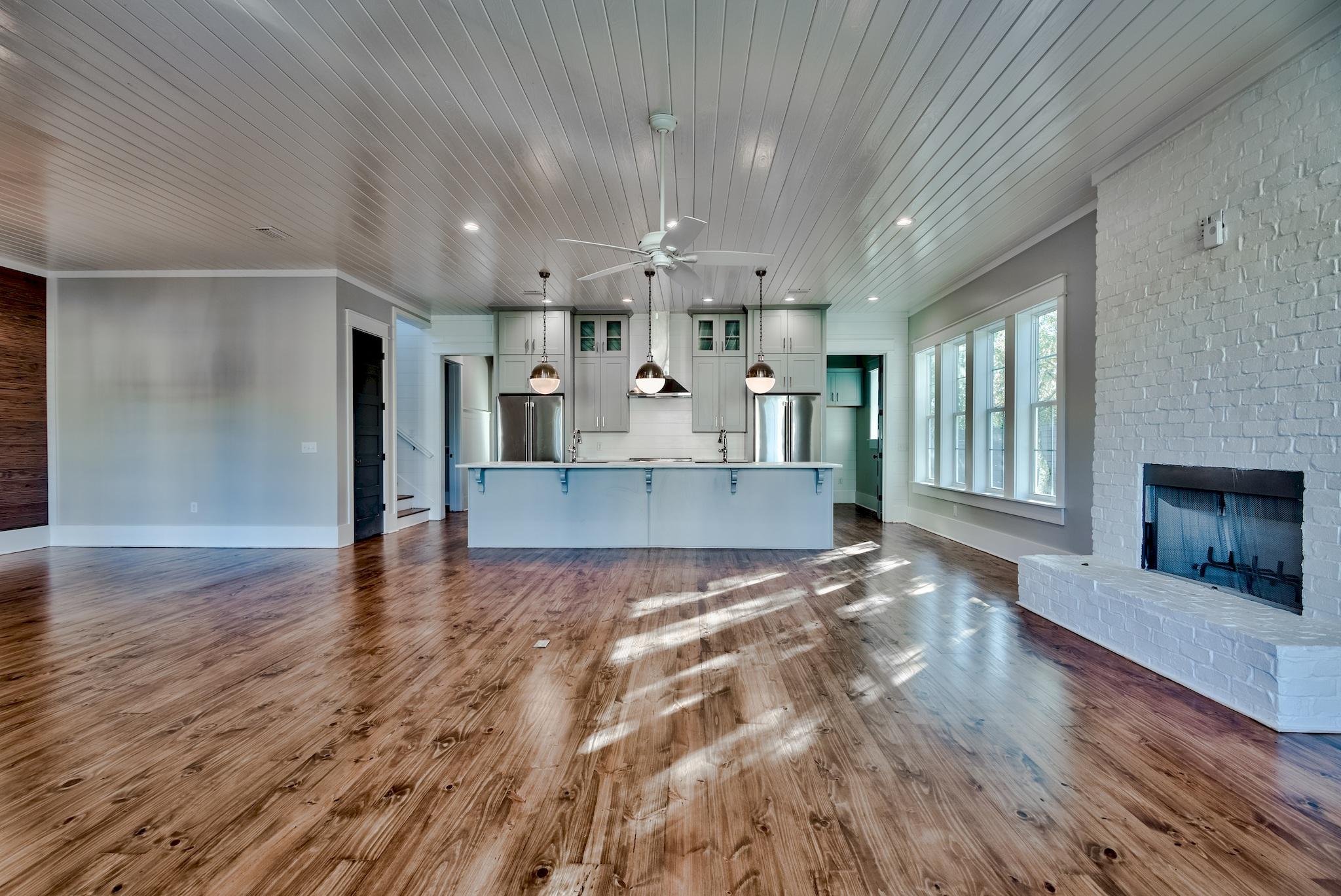160 A St Inlet Beach Inlet Beach, FL 32461 - Photo 7 of 63 a view of a living room and kitchen with granite countertop wooden floor and a fireplace
