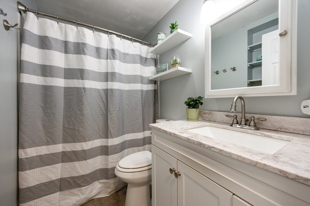 4 Jean Street Blackstone, MA 01504 - Photo 16 of 31 a bathroom with a granite countertop sink toilet a mirror and shower