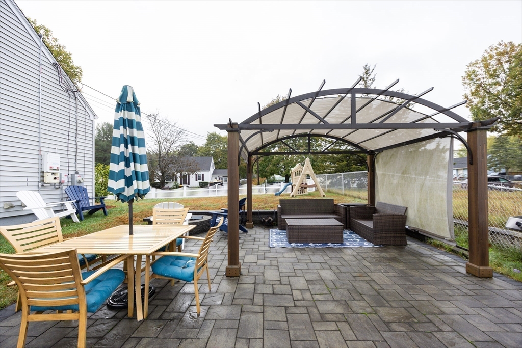 4 Jean Street Blackstone, MA 01504 - Photo 31 of 31 a view of a patio with couches table and chairs under an umbrella