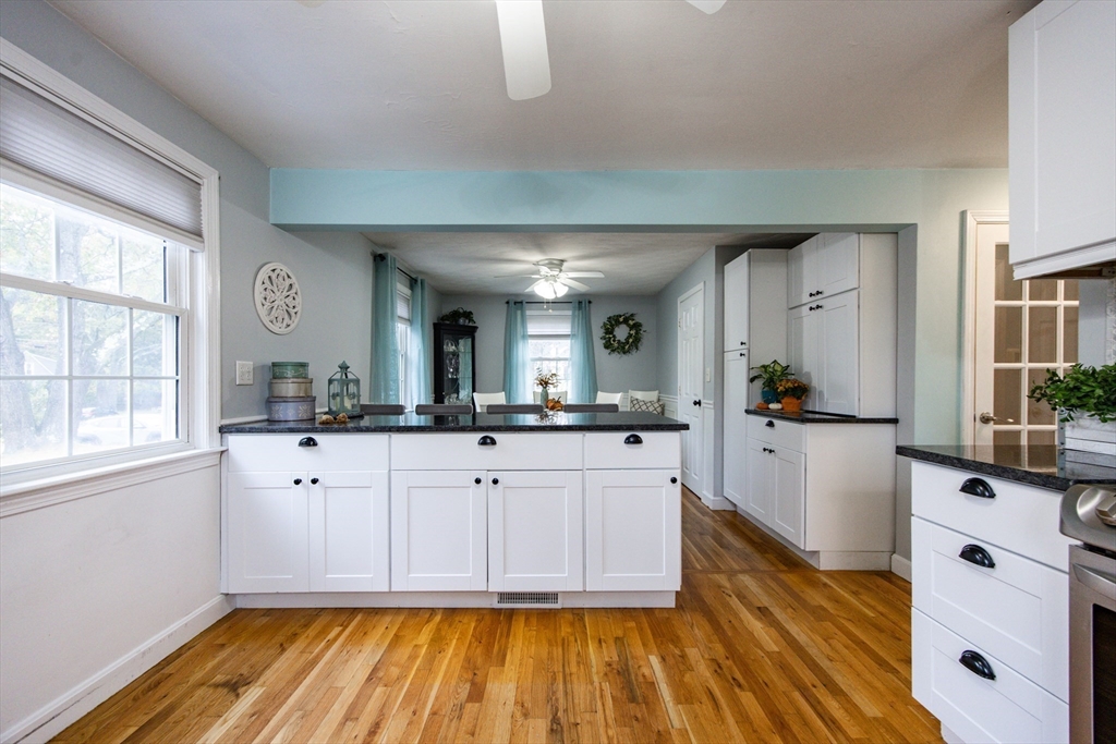 4 Jean Street Blackstone, MA 01504 - Photo 8 of 31 a large white kitchen with sink and wooden floor