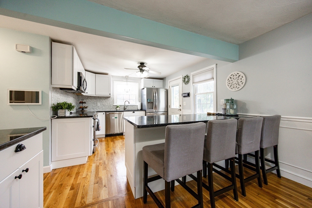 4 Jean Street Blackstone, MA 01504 - Photo 9 of 31 a kitchen with stainless steel appliances granite countertop a table chairs and a refrigerator