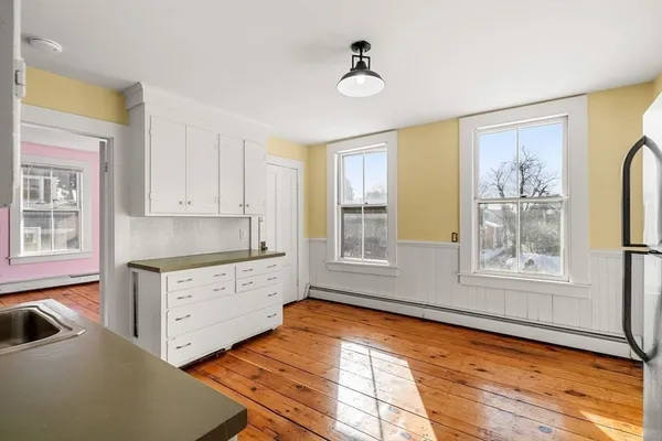 a spacious bedroom with a bed and a window
