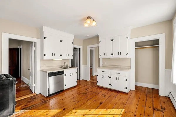 a kitchen with granite countertop a stove a sink and a refrigerator