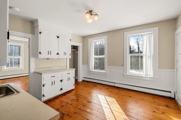 a view of a kitchen with wooden cabinet