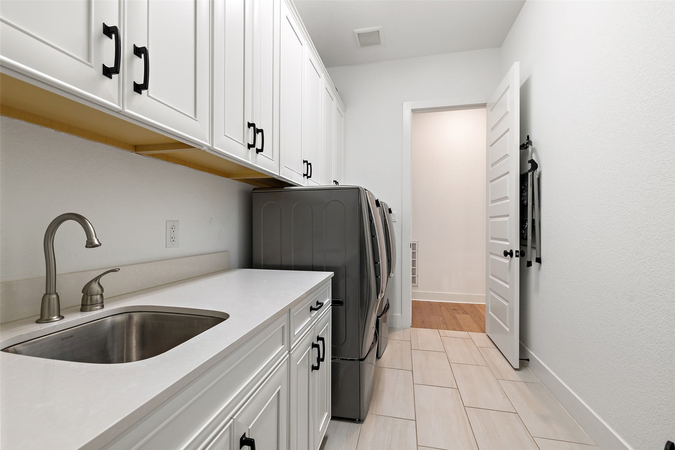 302 Lodestone Lane Austin, TX 78738 - Photo 18 of 40 a kitchen with a sink and refrigerator
