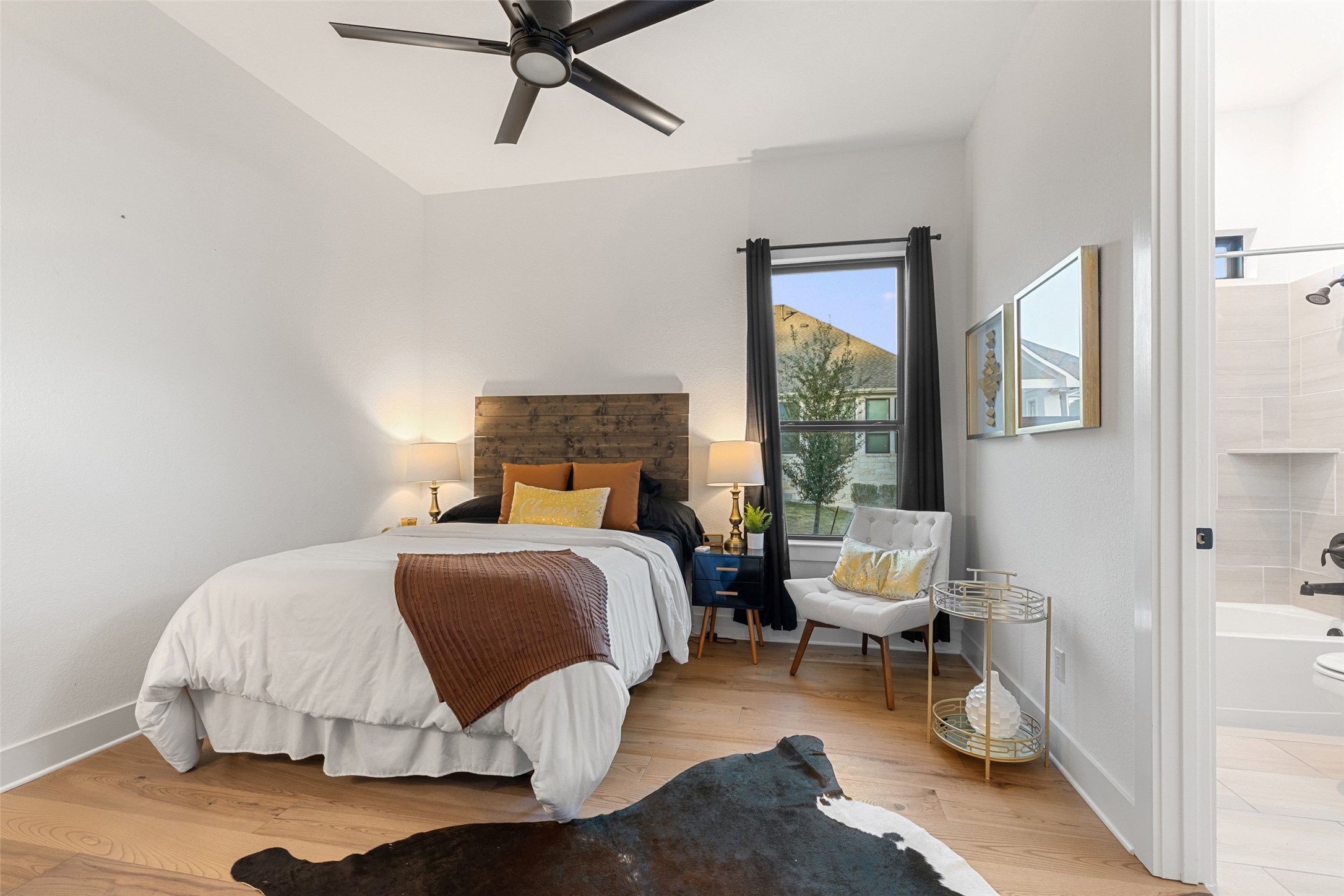 302 Lodestone Lane Austin, TX 78738 - Photo 19 of 40 a bedroom with a bed and wooden floor