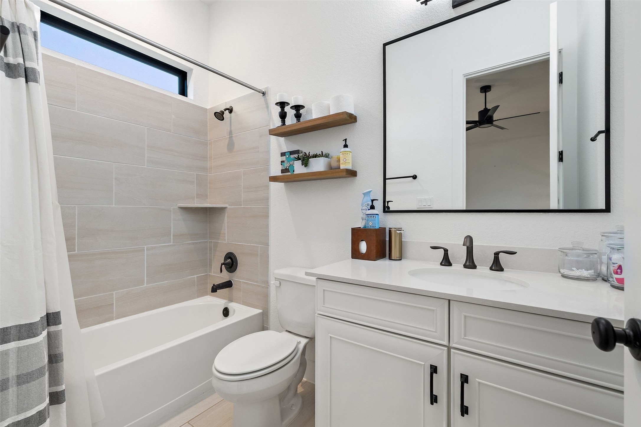 302 Lodestone Lane Austin, TX 78738 - Photo 20 of 40 a bathroom with a sink a toilet and a mirror