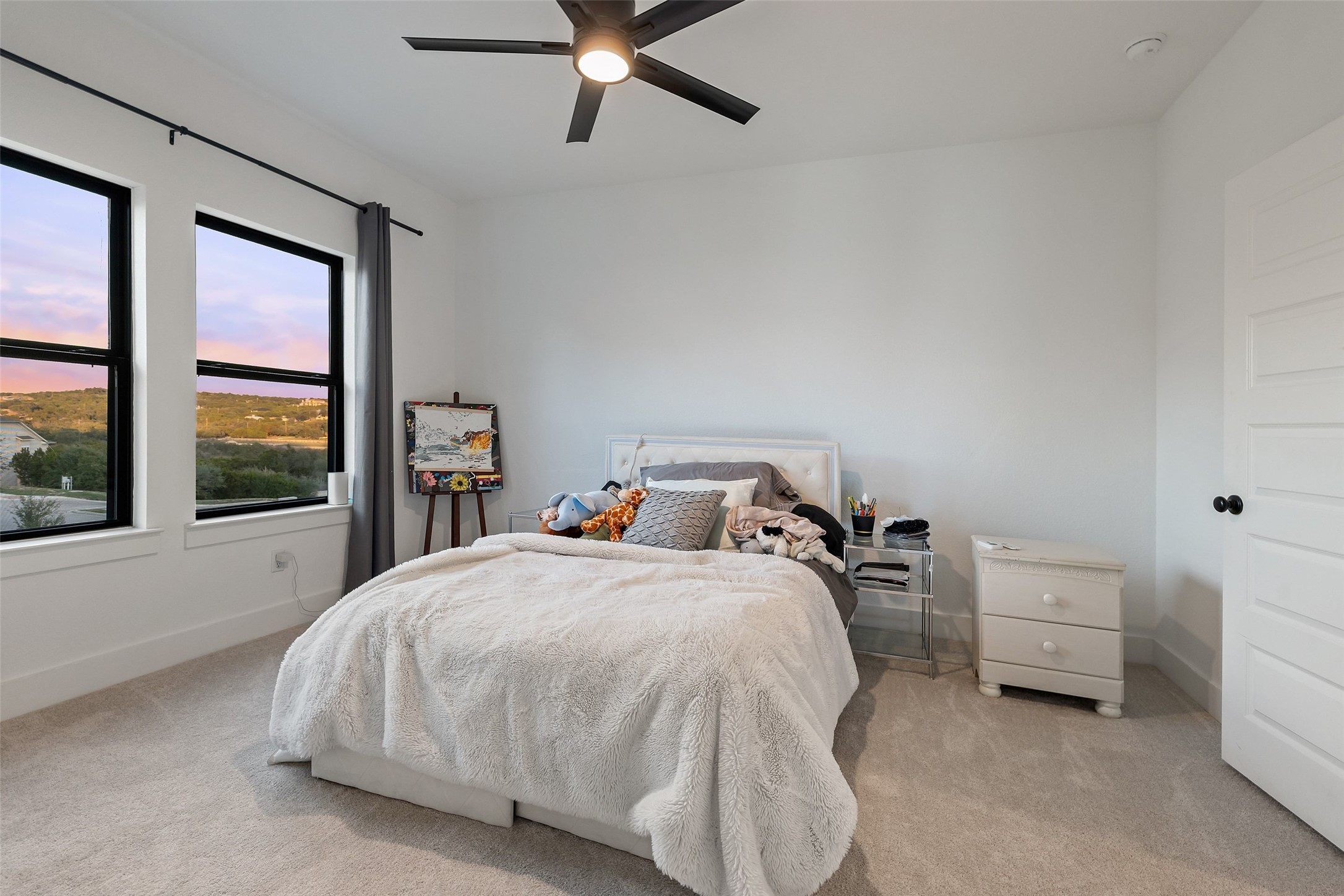 302 Lodestone Lane Austin, TX 78738 - Photo 26 of 40 a bedroom with a bed and a large window