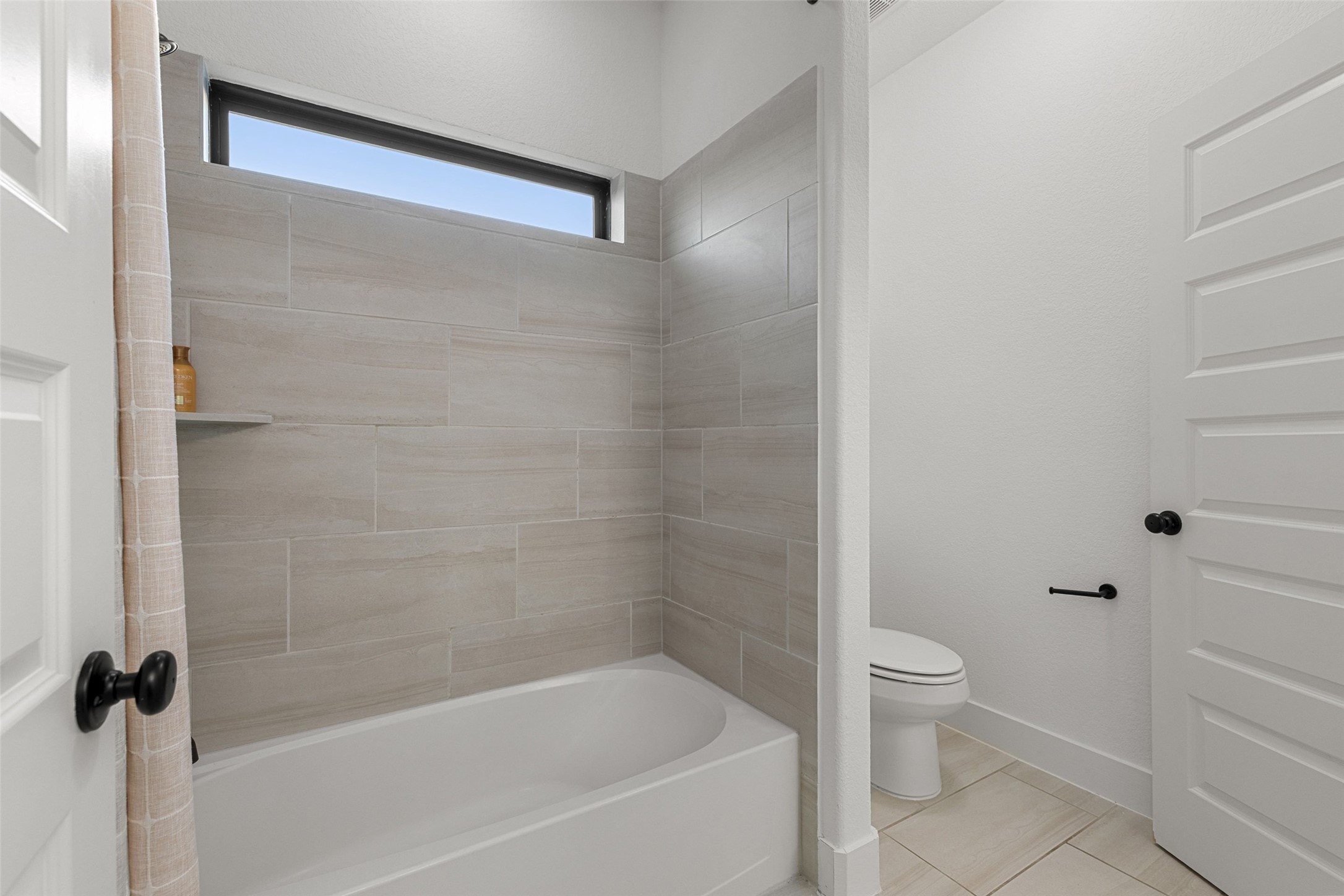 302 Lodestone Lane Austin, TX 78738 - Photo 30 of 40 a white bath tub sitting next to a white toilet and a shower