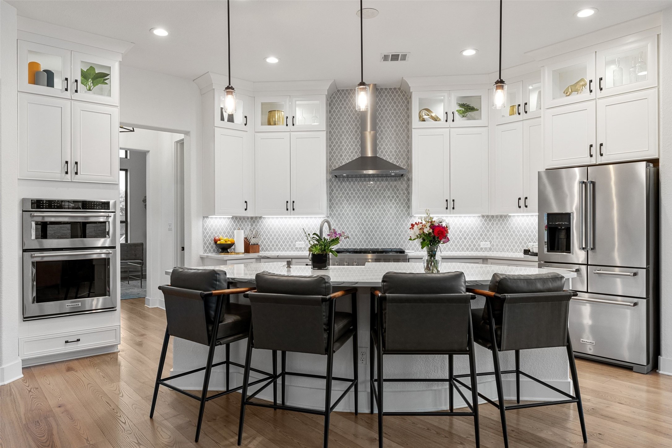 302 Lodestone Lane Austin, TX 78738 - Photo 8 of 40 a kitchen with stainless steel appliances granite countertop a stove a refrigerator a oven a sink a dining table and chairs with wooden floor