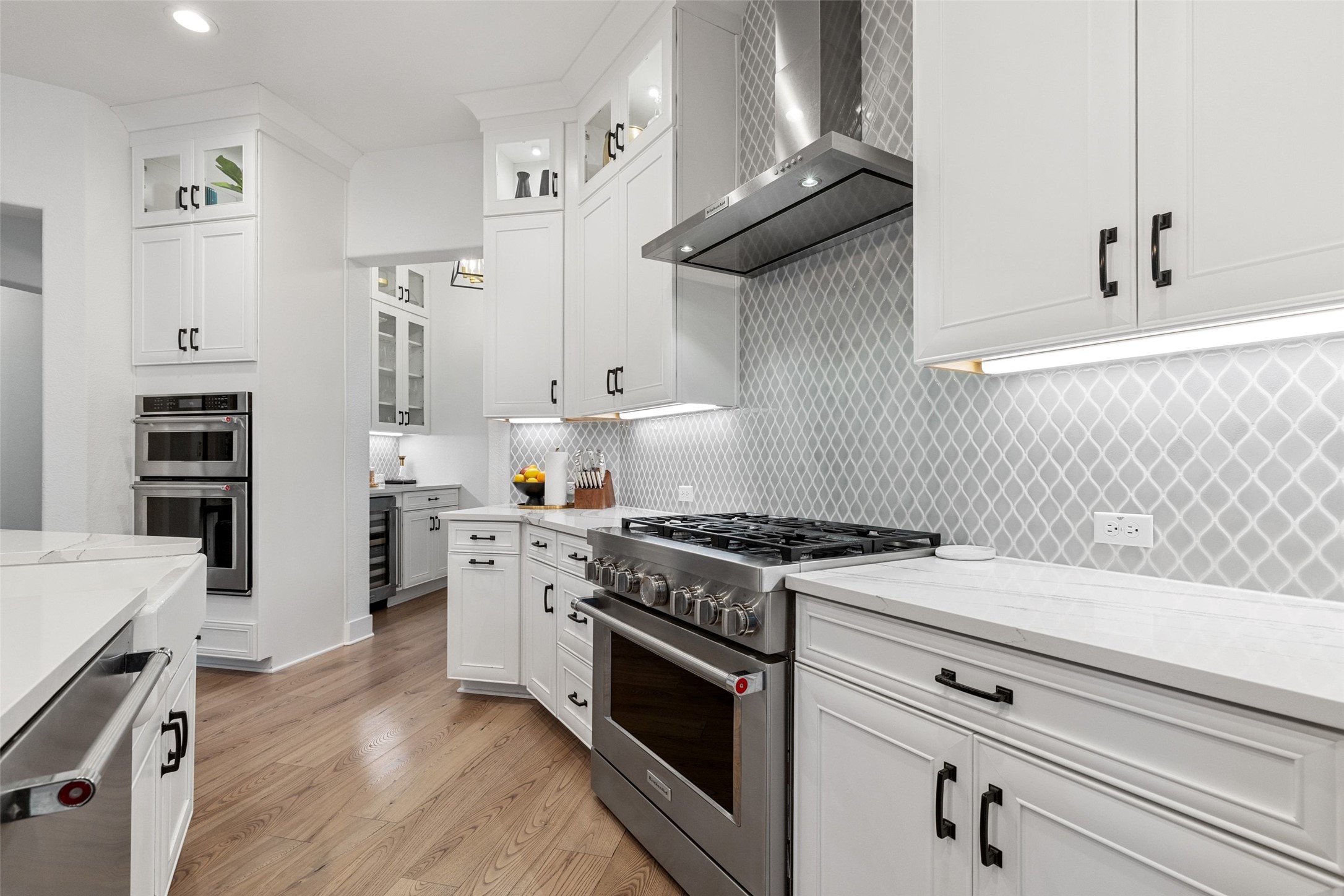 302 Lodestone Lane Austin, TX 78738 - Photo 9 of 40 a kitchen with stainless steel appliances white cabinets and a stove