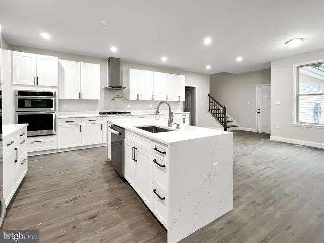 a kitchen with stainless steel appliances a refrigerator sink and cabinets