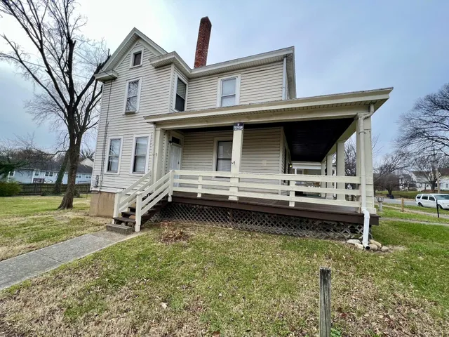 a backyard of a house with barbeque oven