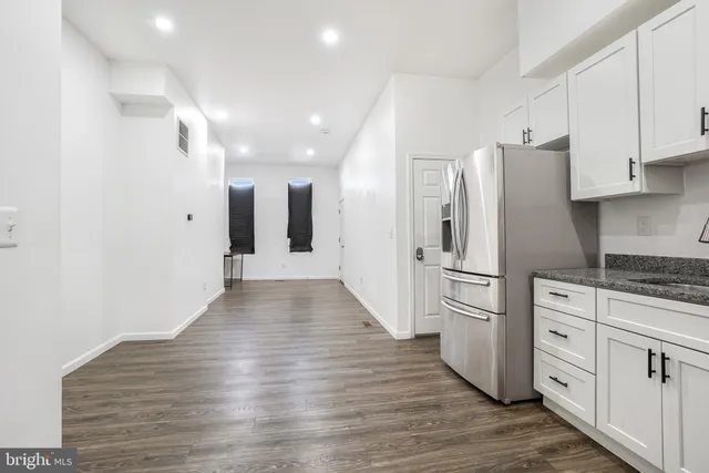 a kitchen with stainless steel appliances granite countertop a sink stove and microwave