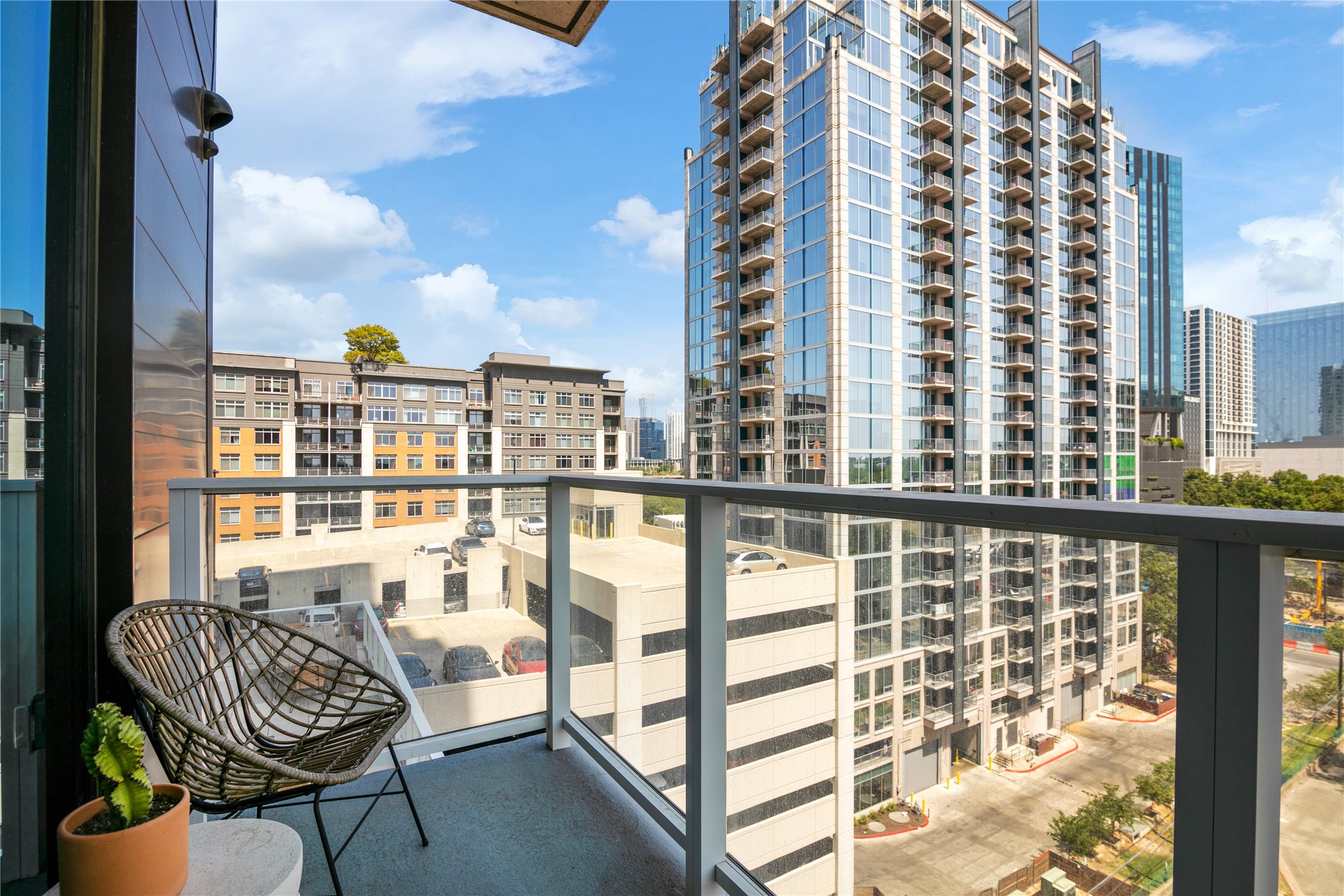 48 East Avenue, Unit 1102 Austin, TX 78701 - Photo 12 of 13 a view of a balcony with chair and tables