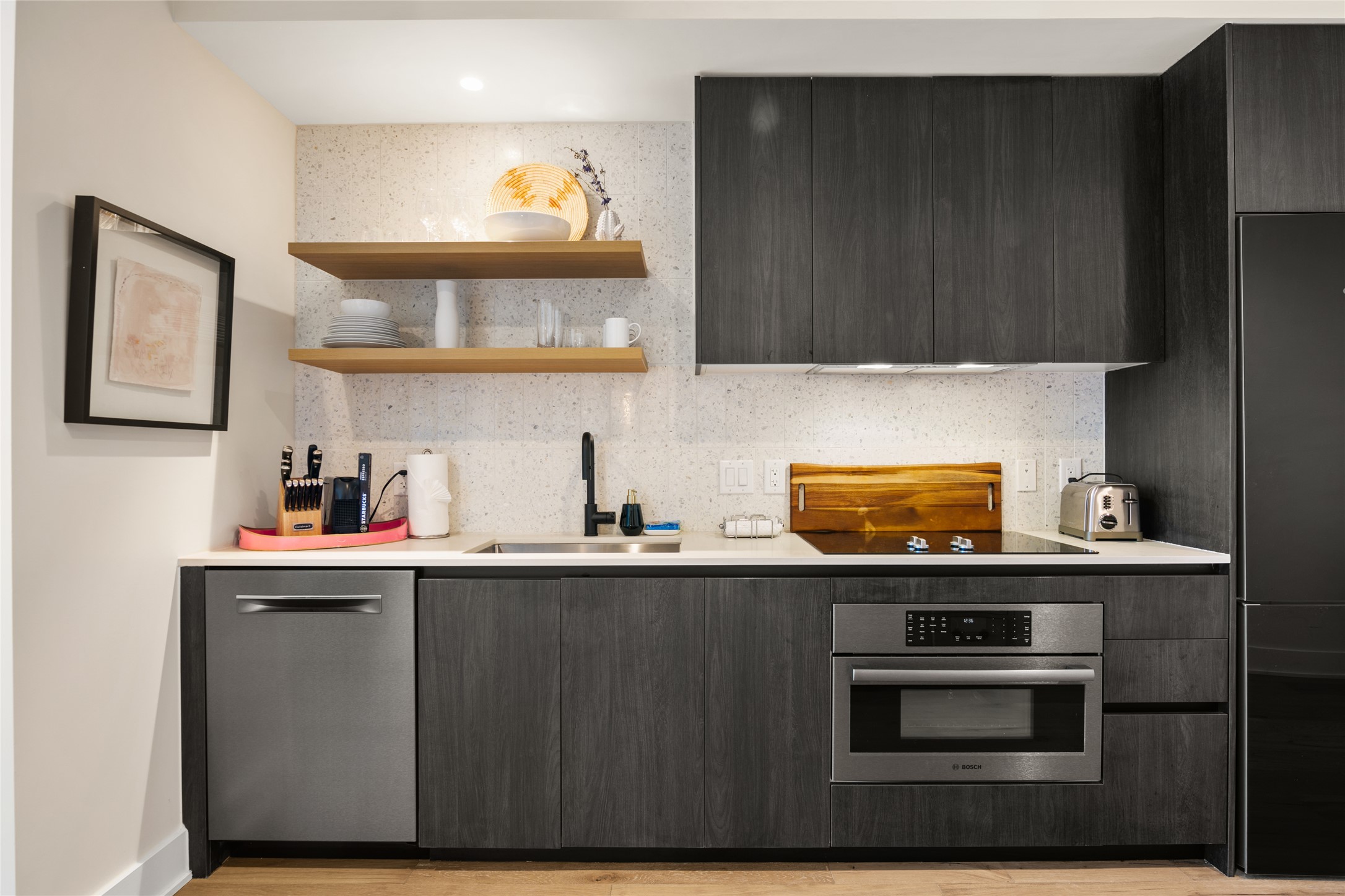 48 East Avenue, Unit 1102 Austin, TX 78701 - Photo 4 of 13 a kitchen with stainless steel appliances a sink a stove and a microwave
