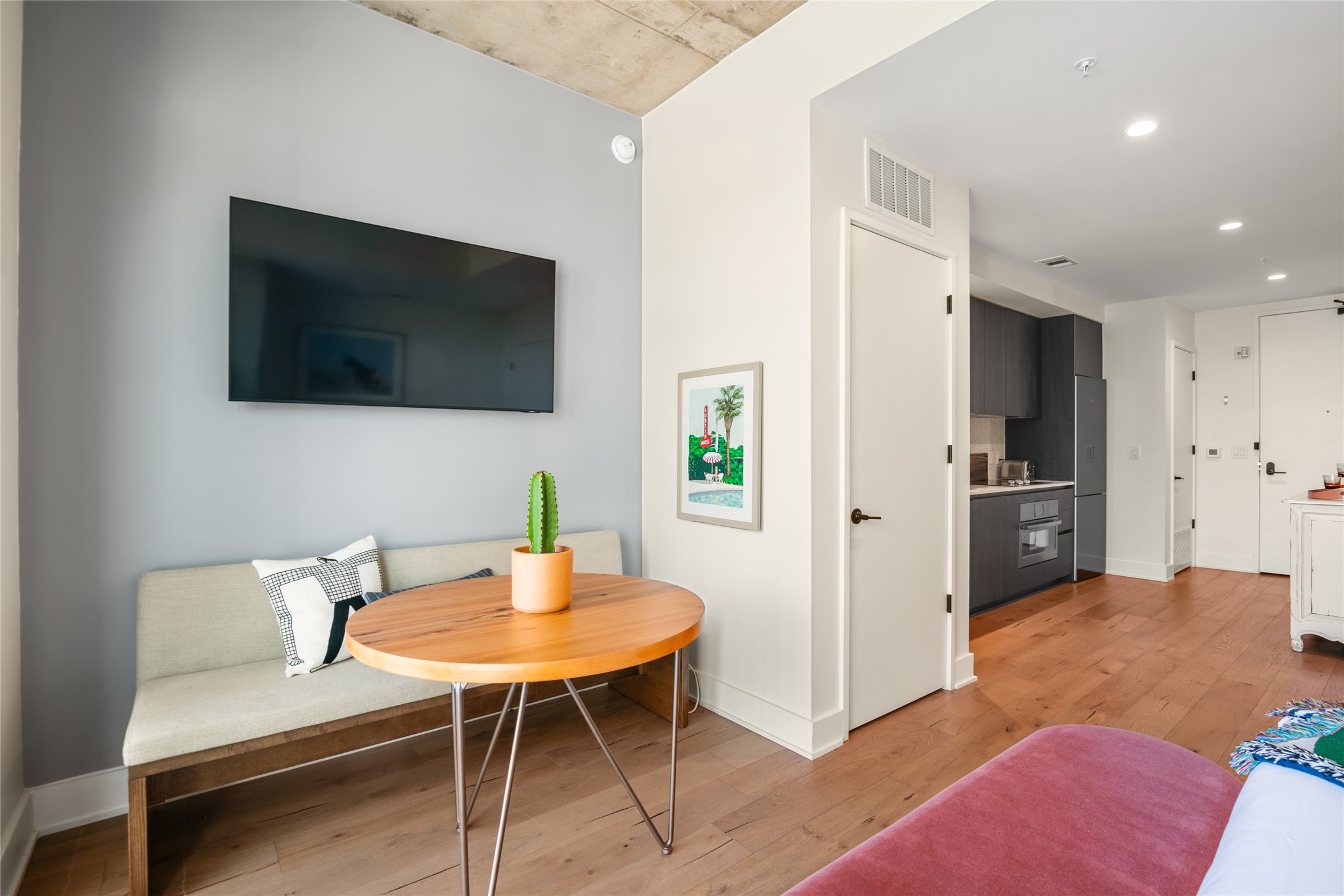 48 East Avenue, Unit 1102 Austin, TX 78701 - Photo 5 of 13 a living room with furniture and a flat screen tv