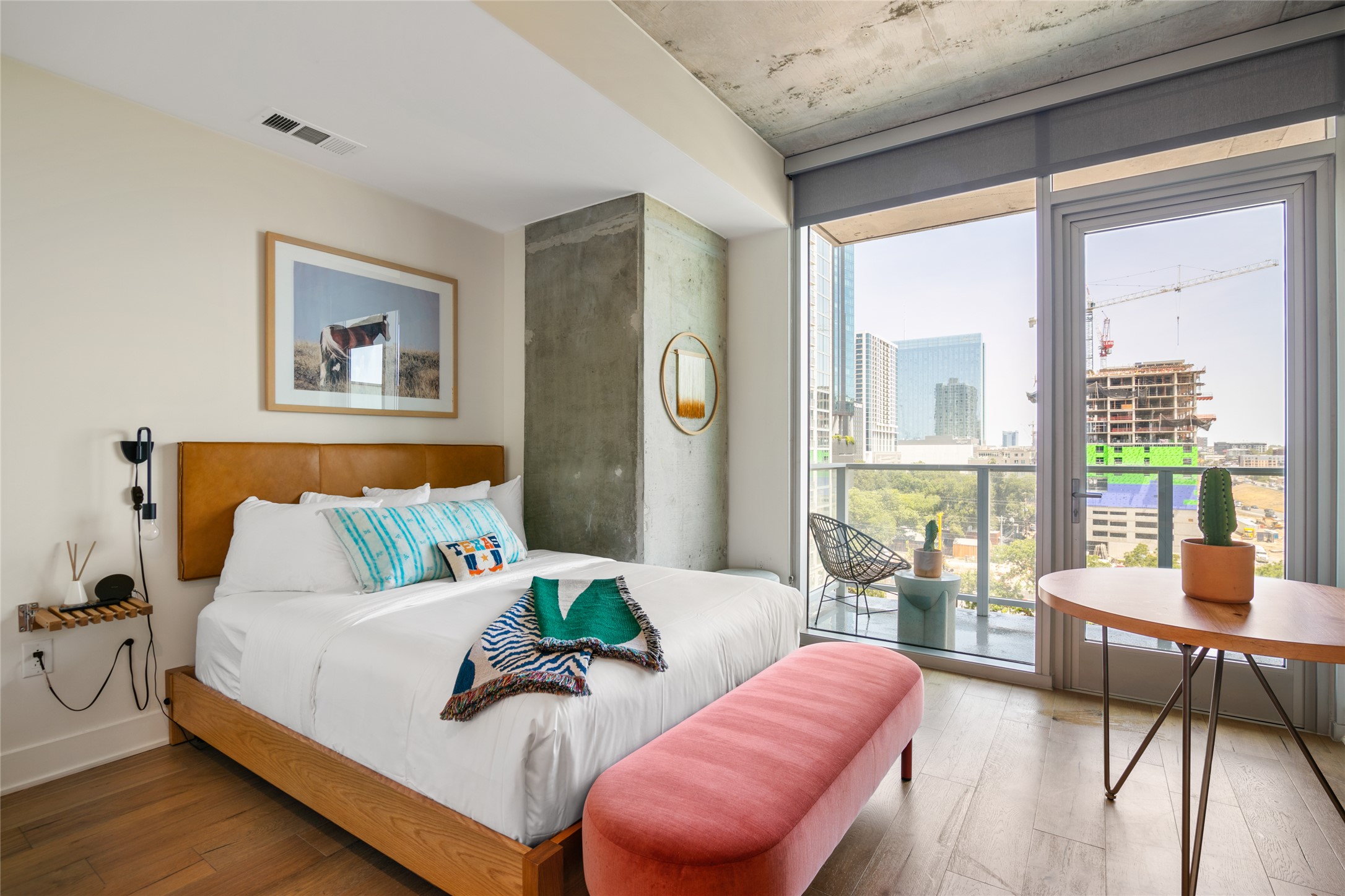 48 East Avenue, Unit 1102 Austin, TX 78701 - Photo 7 of 13 a bedroom with furniture and a large window