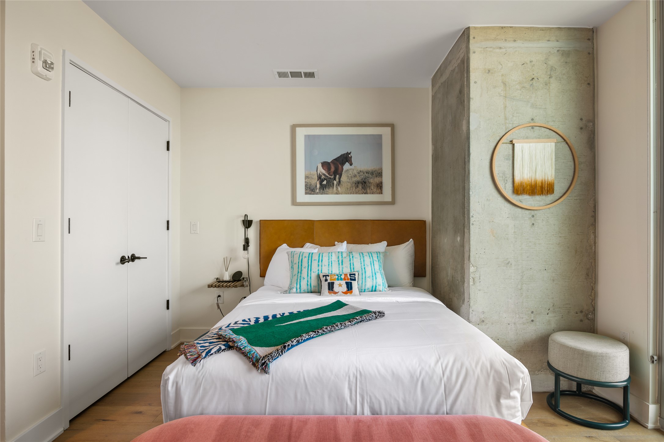 48 East Avenue, Unit 1102 Austin, TX 78701 - Photo 8 of 13 a bedroom with a bed and painting on the wall