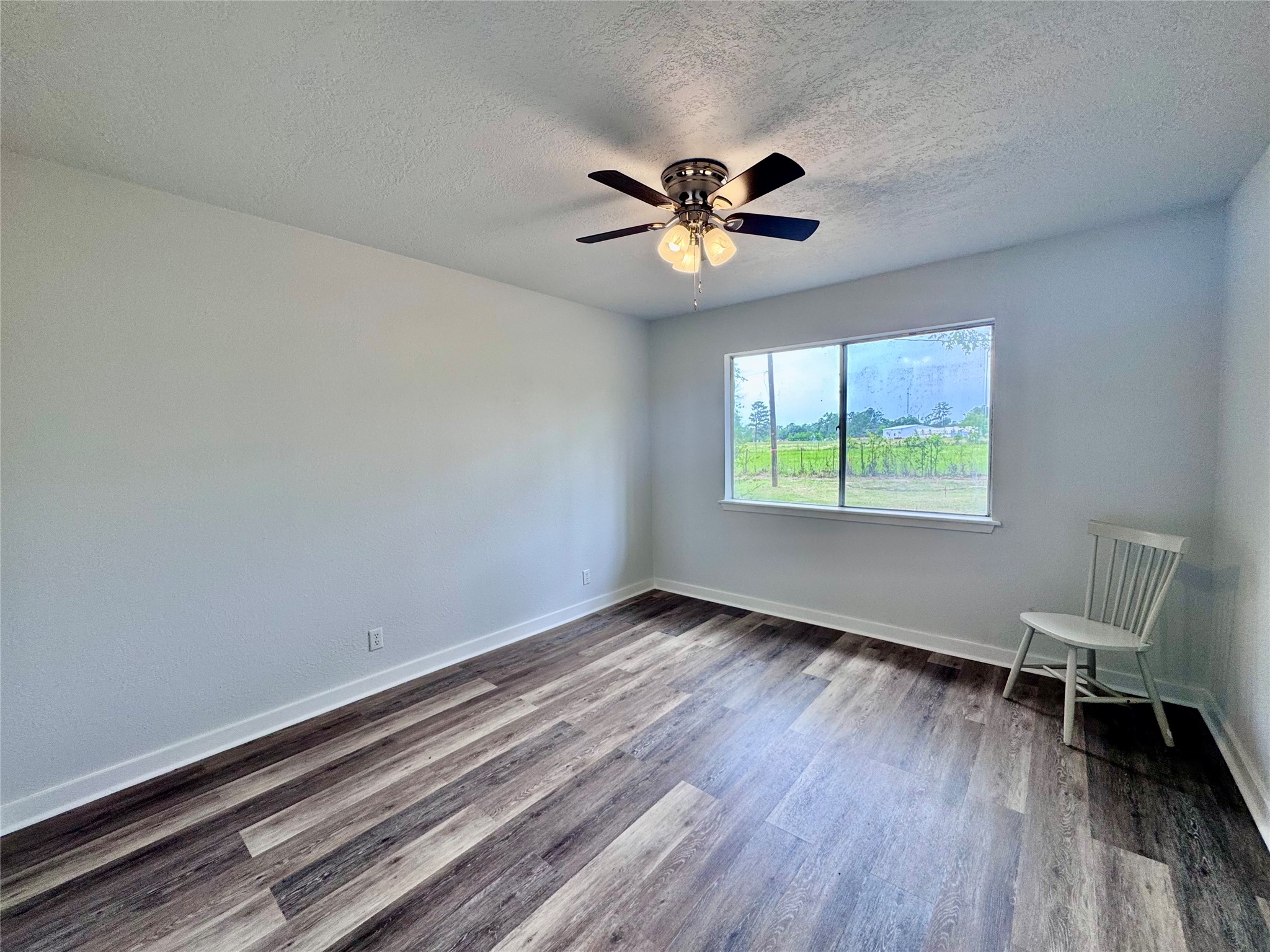 83 Westlake Road Trinity, TX 75862 - Photo 24 of 36 a view of an empty room with wooden floor and a window