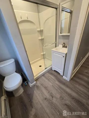 a bathroom with a sink a toilet a mirror and tub