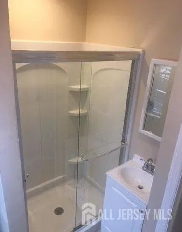 a bathroom with a shower and a sink