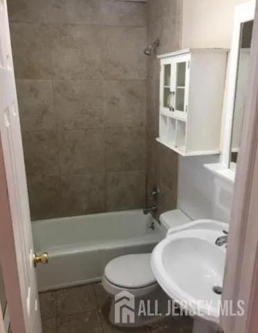 a bathroom with a toilet and a bathtub