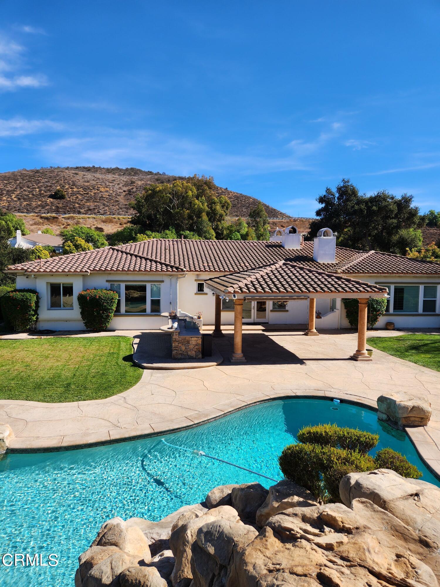 a view of a house with a garden and swimming pool
