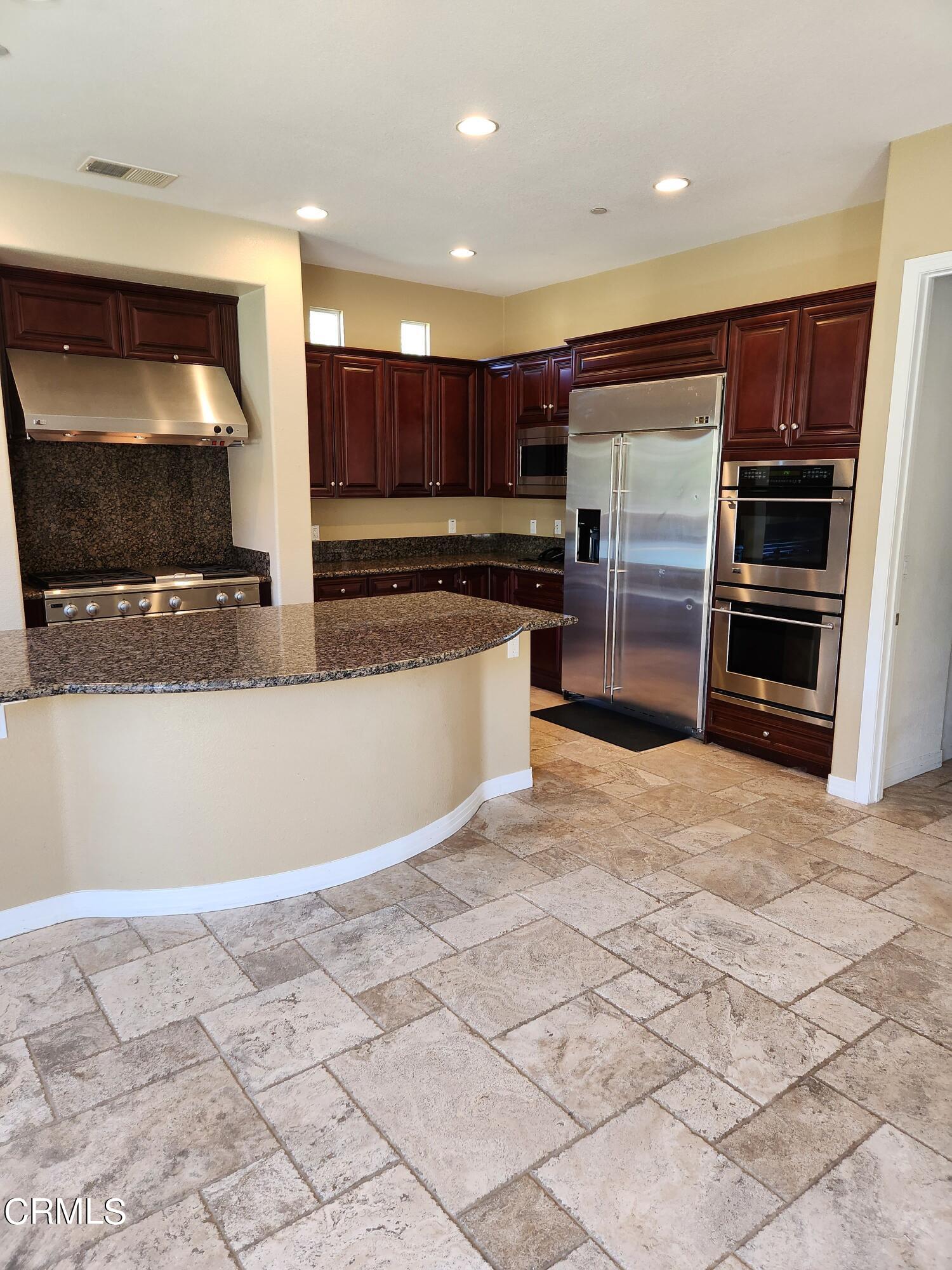 1915 Maya Pradera Lane Moorpark, CA 93021 - Photo 19 of 39 a kitchen with stainless steel appliances granite countertop a refrigerator and a sink