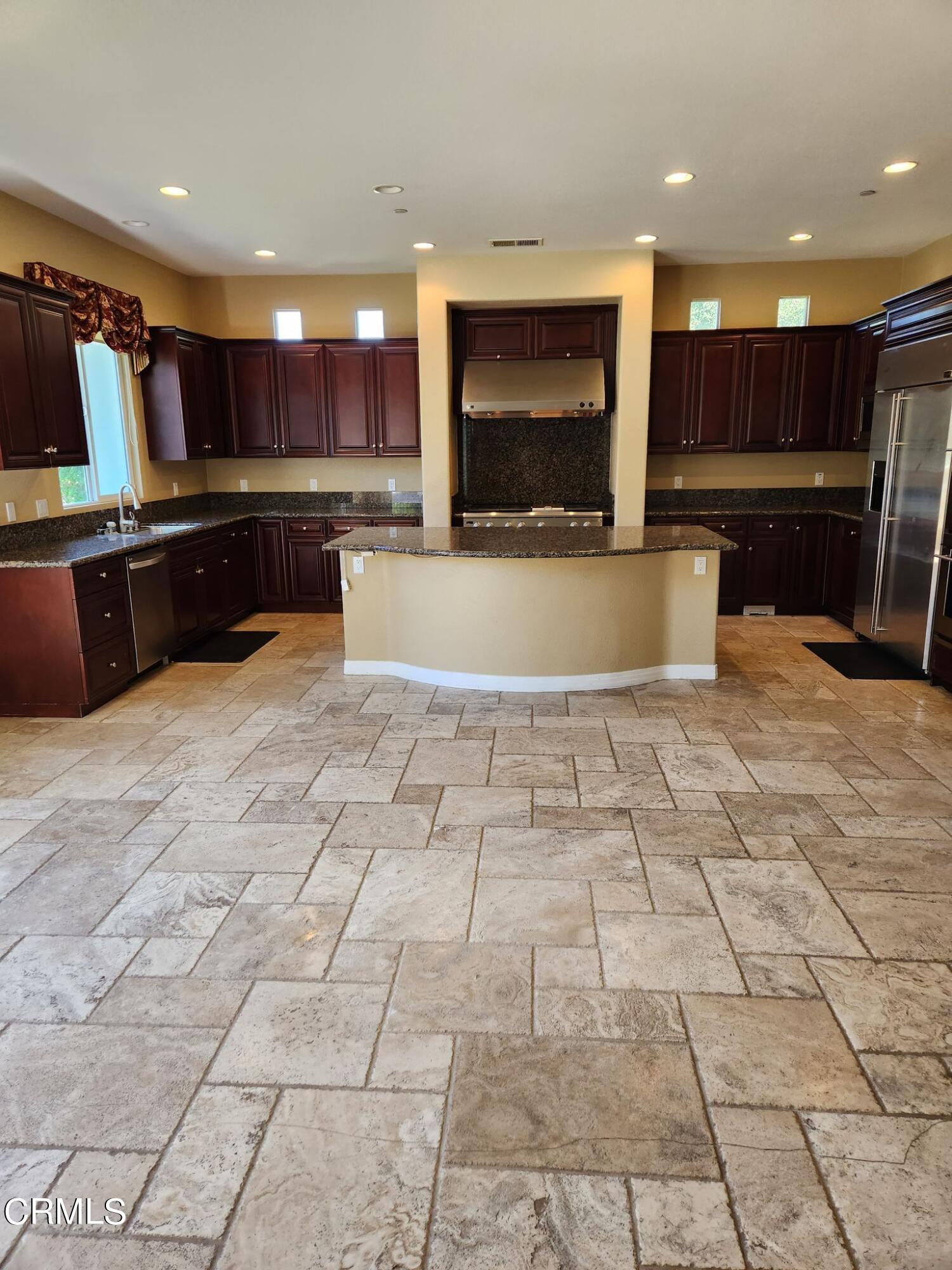 1915 Maya Pradera Lane Moorpark, CA 93021 - Photo 20 of 39 a view of kitchen with stainless steel appliances kitchen island granite countertop a stove a oven and a sink