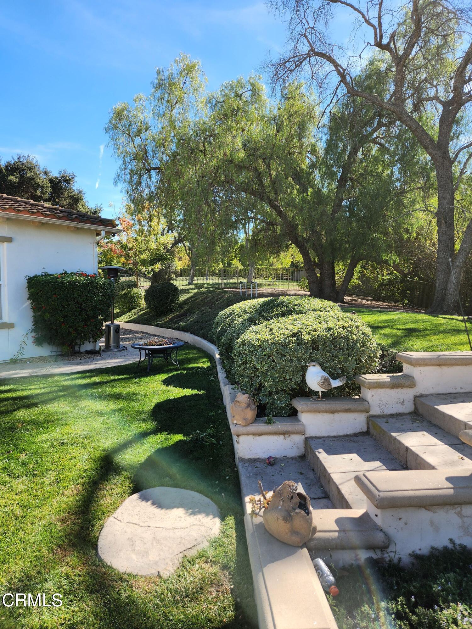 1915 Maya Pradera Lane Moorpark, CA 93021 - Photo 2 of 39 a view of a backyard with plants and a lake view